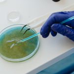Testing Tools - Person Holding Blue Thread on White Table