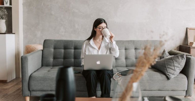 Software Prototypes - Woman Drinking Coffee While Working With Laptop