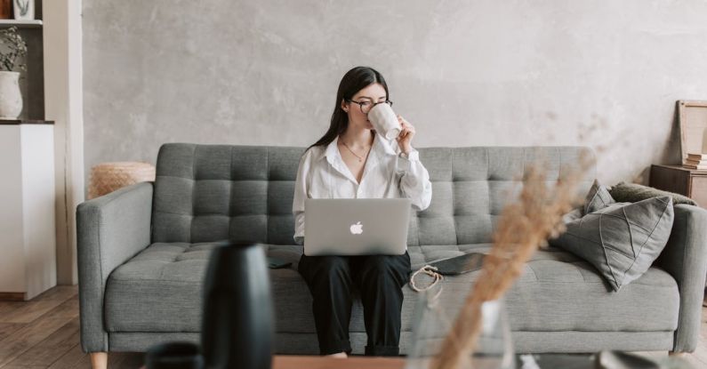 Software Prototypes - Woman Drinking Coffee While Working With Laptop