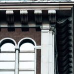 Hybrid Cloud - Old house facade with statue of griffon on roof