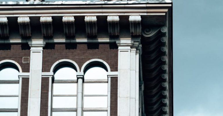 Hybrid Cloud - Old house facade with statue of griffon on roof