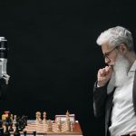 AI Challenges - Elderly Man Thinking while Looking at a Chessboard